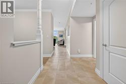 Hall featuring baseboards and light tile patterned floors - 