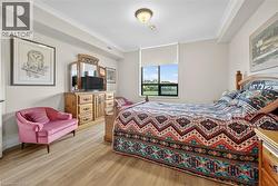 Bedroom with ornamental molding and light wood-style flooring - 