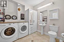 Washroom featuring light tile patterned floors and washer and clothes dryer - 
