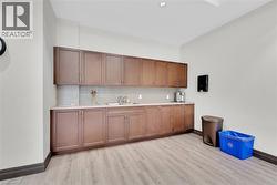 Bar featuring backsplash and light wood finished floors - 