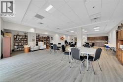 Dining space with light wood-style floors and a drop ceiling - 