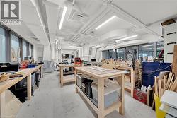 Miscellaneous room featuring unfinished concrete floors and a workshop area - 