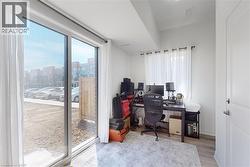 Home office featuring plenty of natural light, light wood-type flooring, and a view of city - 