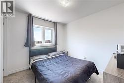 Carpeted bedroom with baseboards - 