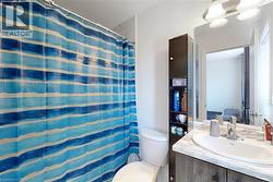Full bathroom with vanity and curtained shower - 