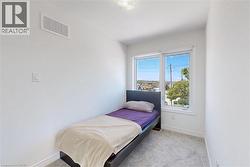 Bedroom with baseboards and light carpet - 