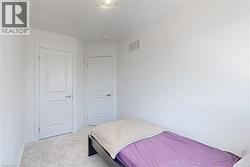 Bedroom featuring light colored carpet and baseboards - 
