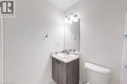Half bath featuring vanity and toilet - 