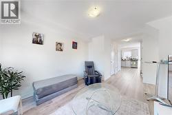 Living area with light wood-style floors and baseboards - 