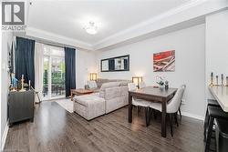 Living room with dark wood-style floors, crown molding, and a tray ceiling - 