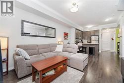 Living area with dark wood finished floors, ornamental molding, and a textured ceiling - 
