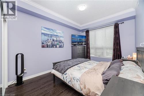 Bedroom with crown molding and wood finished floors - 5317 Upper Middle Road Unit# 112, Burlington, ON - Indoor Photo Showing Bedroom