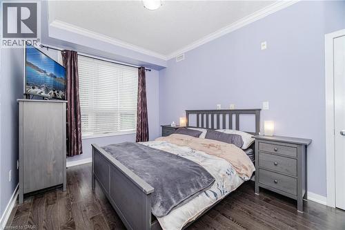 Bedroom with crown molding and dark wood-style flooring - 5317 Upper Middle Road Unit# 112, Burlington, ON - Indoor Photo Showing Bedroom