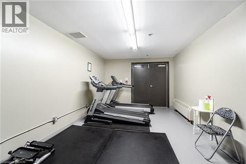 Exercise room with a wall mounted air conditioner - 5317 Upper Middle Road Unit# 112, Burlington, ON - Indoor Photo Showing Gym Room