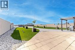 View of property's community featuring a pergola, a fenced backyard, and a patio area - 