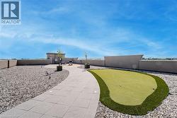 View of property's community with an area to practice putting and a fenced backyard - 