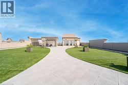View of front of home with a fenced backyard and a patio area - 