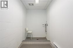 Washroom with a baseboard heating unit and tile patterned floors - 