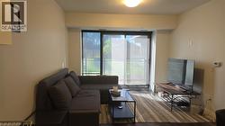 Living area with wood finished floors and baseboards - 