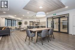 Dining room featuring light wood-style floors, recessed lighting, and french doors - 