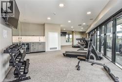 Workout area with light carpet, beverage cooler, and recessed lighting - 