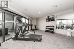 Workout room with light colored carpet and recessed lighting - 