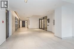 Hallway featuring a barn door and light tile patterned floors - 