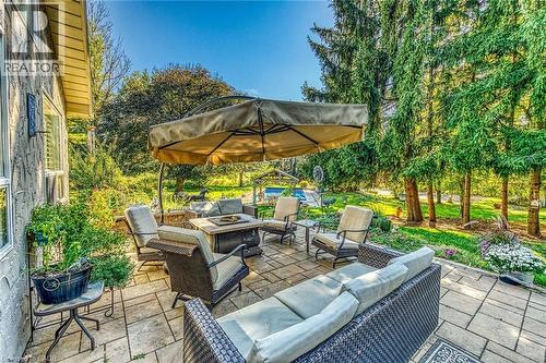 View of patio / terrace featuring an outdoor living space with a fire pit - 5590 Blind Line, Burlington, ON - Outdoor With Deck Patio Veranda