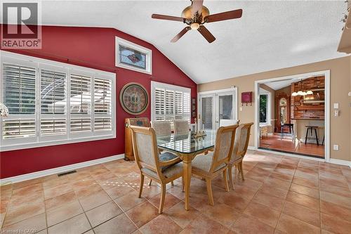 Dining area featuring light tile patterned floors, a textured ceiling, lofted ceiling, and ceiling fan - 5590 Blind Line, Burlington, ON - Indoor Photo Showing Dining Room