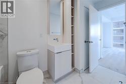 Bathroom featuring vanity and light marble finish flooring - 