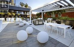 View of patio with outdoor dining area, outdoor lounge area, and an outdoor kitchen - 