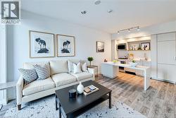 Living area featuring light wood finished floors and track lighting - 