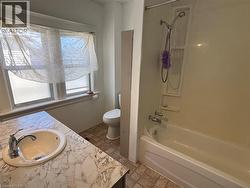 Full bathroom with bathing tub / shower combination and vanity - 