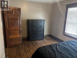 Bedroom featuring dark wood-style floors - 