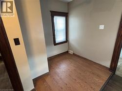 Empty room featuring wood finished floors and baseboards - 