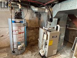Utility room with gas water heater and heating unit - 