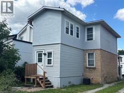 Rear view of property featuring stucco siding and brick siding - 