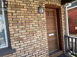 Doorway to property featuring brick siding - 