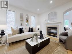 Living area with plenty of natural light, recessed lighting, a premium fireplace, and light wood-type flooring - 