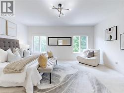 Carpeted bedroom featuring baseboards and a chandelier - 
