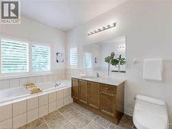 Full bathroom with a bath, vanity, and light tile patterned floors - 