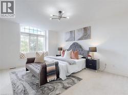 Bedroom with carpet floors and a chandelier - 