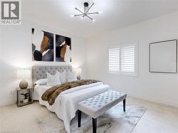 Bedroom with a chandelier and light colored carpet - 