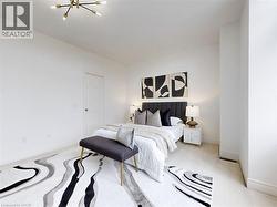 Carpeted bedroom featuring a chandelier and baseboards - 