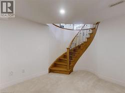 Staircase featuring carpet flooring and baseboards - 