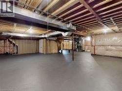 Unfinished below grade area with stairway and heating unit - 