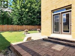 Fenced backyard featuring a patio area - 