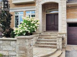 Entrance to property with stone siding and brick siding - 