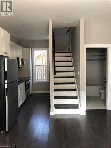 Staircase with wood-type flooring and baseboards - 552 7Th Avenue, Hanover, ON - Indoor