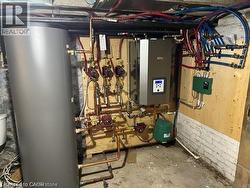 Utility room featuring gas water heater and water heater - 